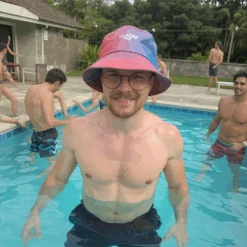 HSM Bucket Hat -Hockey Stick Market openart at a pool party wearing this hat shirtless having a good time with a smile cGMRLRQZ upscaled